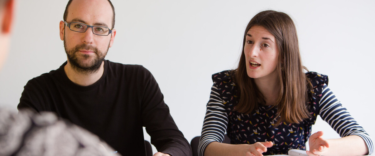 A man and woman in a meeting
